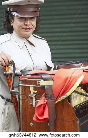 Portrait of a female musician standing with an accordion View Large Photo Image Stock Image - Portrait of a female musician standing with an accordion. Fotosearch