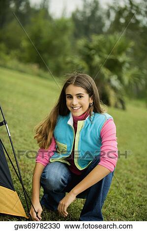Portrait of a girl adjusting a tent View Large Photo Image Stock Image - Portrait of a girl adjusting a tent. Fotosearch