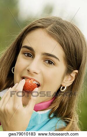 Portrait of a girl eating a strawberry View Large Photo Image Stock Image - Portrait of a girl eating a strawberry. Fotosearch