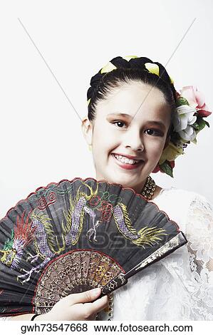 Portrait of a girl holding a folding fan and smiling View Large Photo Image Stock Photo - Portrait of a girl holding a folding fan and smiling. Fotosearch