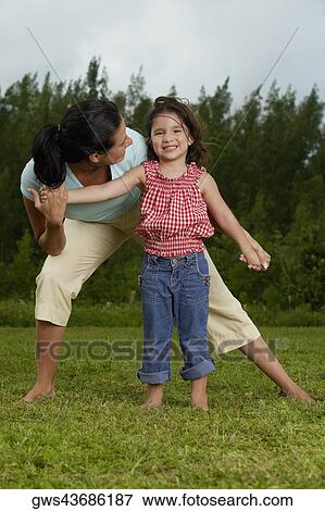 Portrait of a girl holding her mother's hand and smiling View Large Photo Image Stock Photo - Portrait of a girl holding her mother's hand and smiling. Fotosearch