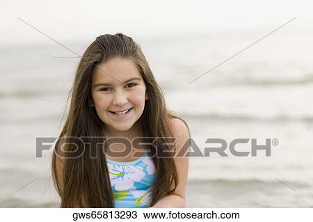 Portrait of a girl smiling on the beach View Large Photo Image Stock Image - Portrait of a girl smiling on the beach. Fotosearch