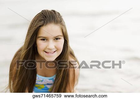 Stock Photo - Portrait of a girl smiling. Fotosearch