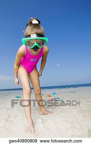 Portrait of a girl standing on the beach and wearing a scuba mask View Large Photo Image Stock Photo - Portrait of a girl standing on the beach and wearing a scuba mask. Fotosearch