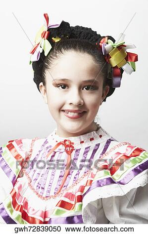 Stock Image - Portrait of a girl wearing traditional clothing and smiling. Fotosearch