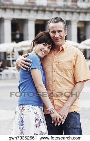 Portrait of a mature man and a young woman embracing each other View Large Photo Image Stock Image - Portrait of a mature man and a young woman embracing each other . Fotosearch