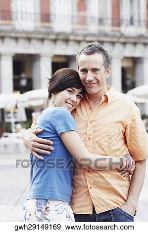 Portrait of a mature man and a young woman embracing each other View Large Photo Image Stock Photo - Portrait of a mature man and a young woman embracing each other . Fotosearch
