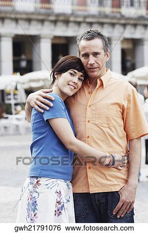 Portrait of a mature man and a young woman embracing each other View Large Photo Image Stock Photograph - Portrait of a mature man and a young woman embracing each other . Fotosearch