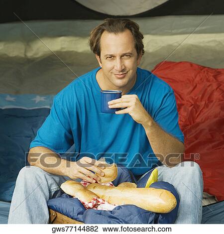 Portrait of a mature man holding a mug and a piece of bread View Large Photo Image Stock Image - Portrait of a mature man holding a mug and a piece of bread. Fotosearch