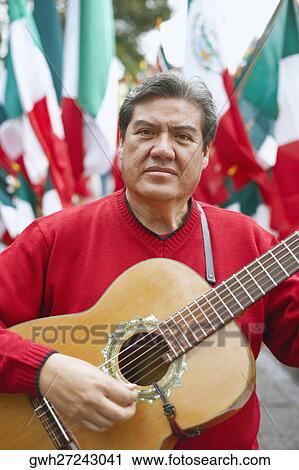 Stock Image - Portrait of a mature man playing the guitar. Fotosearch