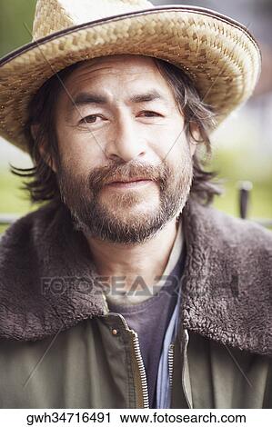 Stock Image - Portrait of a mature man smirking. Fotosearch