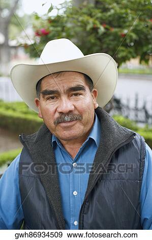Stock Photo - Portrait of a mature man wearing a cowboy hat. Fotosearch