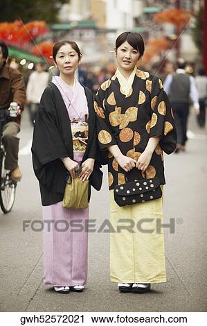 Portrait of a mature woman and her daughter standing together View Large Photo Image Stock Image - Portrait of a mature woman and her daughter standing together . Fotosearch