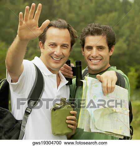 Stock Image - Portrait of a mid adult man and a mature man gesturing. Fotosearch