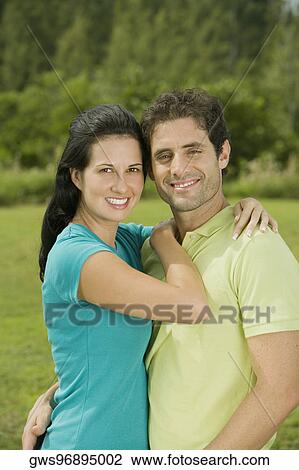 Portrait of a mid adult man and a young woman embracing each other View Large Photo Image Stock Image - Portrait of a mid adult man and a young woman embracing each other. Fotosearch