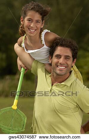 Portrait of a mid adult man carrying his daughter on his shoulders and holding a butterfly net View Large Photo Image Stock Photo - Portrait of a mid adult man carrying his daughter on his shoulders and holding a butterfly net. Fotosearch