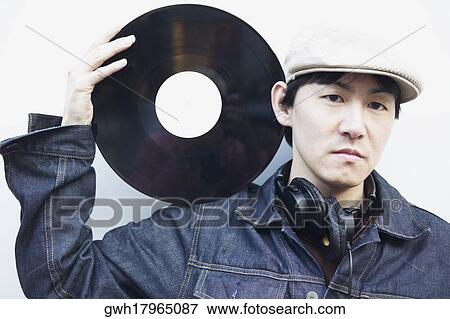 Portrait of a mid adult man holding a record on his shoulder View Large Photo Image Stock Photo - Portrait of a mid adult man holding a record on his shoulder. Fotosearch