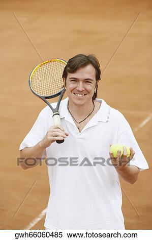 Portrait of a mid adult man holding tennis balls and a tennis racket View Large Photo Image Stock Photography - Portrait of a mid adult man holding tennis balls and a tennis racket. Fotosearch