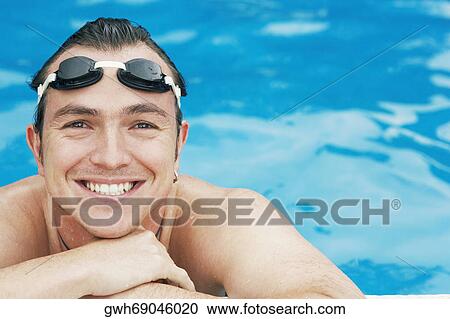 Portrait of a mid adult man leaning at the edge of a swimming pool View Large Photo Image Stock Image - Portrait of a mid adult man leaning at the edge of a swimming pool. Fotosearch