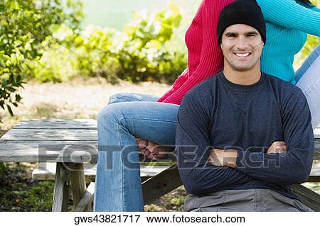 Portrait of a mid adult man sitting in front of two young women View Large Photo Image Stock Photo - Portrait of a mid adult man sitting in front of two young women. Fotosearch