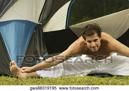 Stock Photography - Portrait of a mid adult man stretching his legs. Fotosearch