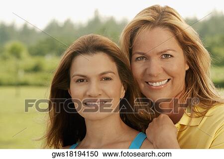 Portrait of a mid adult woman and a mature woman smiling View Large Photo Image Stock Image - Portrait of a mid adult woman and a mature woman smiling. Fotosearch