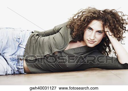 Stock Photo - Portrait of a mid adult woman lying on the floor. Fotosearch