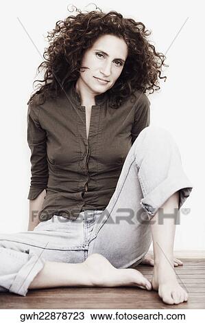 Portrait of a mid adult woman sitting on the floor View Large Photo Image Stock Image - Portrait of a mid adult woman sitting on the floor. Fotosearch