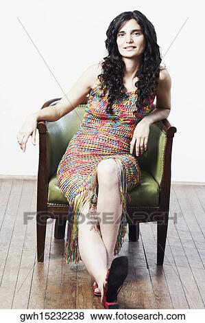 Stock Photo - Portrait of a mid adult woman sitting in an armchair. Fotosearch