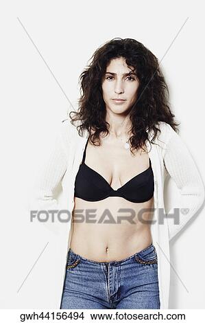 Portrait of a mid adult woman standing with her hands behind her back View Large Photo Image Picture - Portrait of a mid adult woman standing with her hands behind her back. Fotosearch
