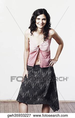 Portrait of a mid adult woman standing with her hand on her waist View Large Photo Image Stock Photo - Portrait of a mid adult woman standing with her hand on her waist. Fotosearch