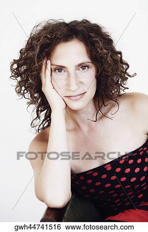 Portrait of a mid adult woman with her hand on her face View Large Photo Image Stock Photograph - Portrait of a mid adult woman with her hand on her face. Fotosearch