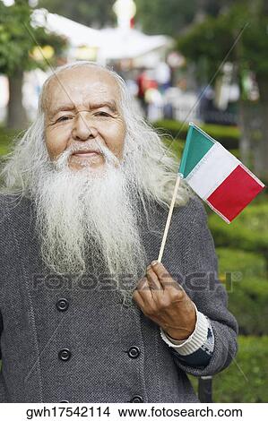 Portrait of a senior man holding a Mexican flag View Large Photo Image Picture - Portrait of a senior man holding a Mexican flag. Fotosearch