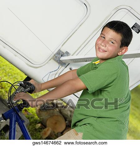 Portrait of a teenage boy riding a bicycle View Large Photo Image Stock Image - Portrait of a teenage boy riding a bicycle. Fotosearch