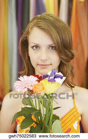 Portrait of a teenage girl holding a bouquet of flowers View Large Photo Image Stock Image - Portrait of a teenage girl holding a bouquet of flowers. Fotosearch