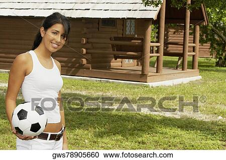 Portrait of a teenage girl holding a soccer ball and smiling View Large Photo Image Stock Image - Portrait of a teenage girl holding a soccer ball and smiling. Fotosearch
