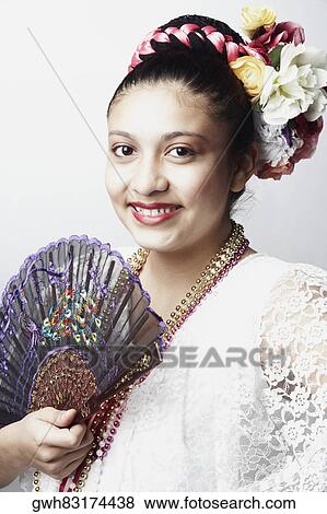 Portrait of a teenage girl holding a folding fan and smiling View Large Photo Image Stock Photo - Portrait of a teenage girl holding a folding fan and smiling. Fotosearch