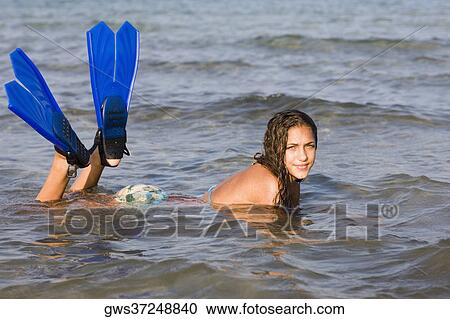 Portrait of a teenage girl lying in water and wearing flippers View Large Photo Image Stock Image - Portrait of a teenage girl lying in water and wearing flippers. Fotosearch