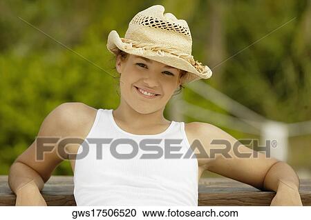Portrait of a teenage girl posing against a wooden bench and smiling View Large Photo Image Stock Image - Portrait of a teenage girl posing against a wooden bench and smiling. Fotosearch
