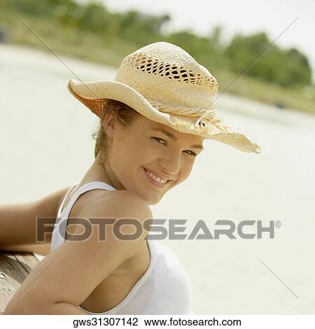 Portrait of a teenage girl posing against a wooden bench and smiling View Large Photo Image Stock Image - Portrait of a teenage girl posing against a wooden bench and smiling. Fotosearch