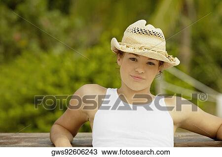 Portrait of a teenage girl wearing a sun hat View Large Photo Image Stock Image - Portrait of a teenage girl wearing a sun hat. Fotosearch