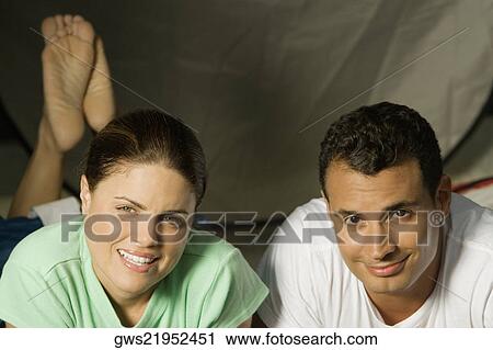 Portrait of a young couple lying down View Large Photo Image Stock Image - Portrait of a young couple lying down. Fotosearch
