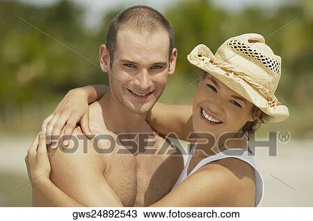 Portrait of a young man and a teenage girl embracing each other View Large Photo Image Stock Image - Portrait of a young man and a teenage girl embracing each other. Fotosearch