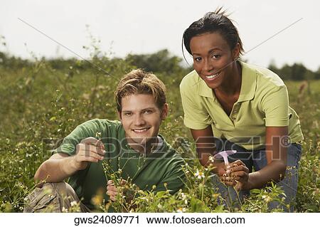 Portrait of a young man and a young woman in a field View Large Photo Image Stock Image - Portrait of a young man and a young woman in a field. Fotosearch