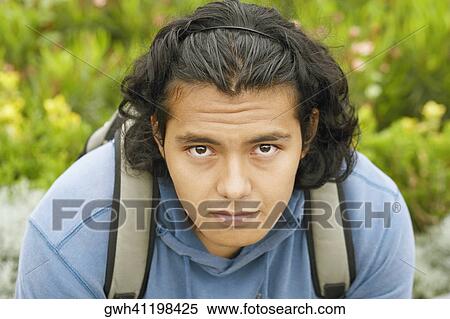 Portrait of a young man carrying a backpack View Large Photo Image Stock Photography - Portrait of a young man carrying a backpack. Fotosearch