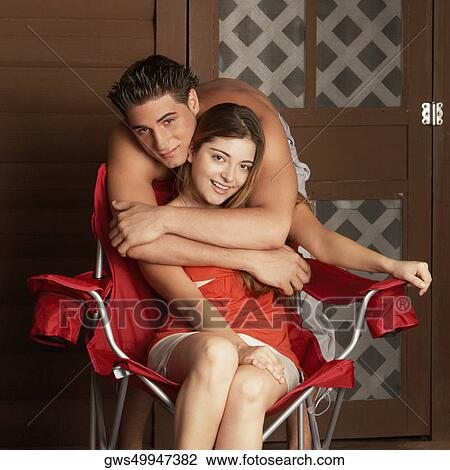 Portrait of a young man embracing a young woman from behind View Large Photo Image Stock Image - Portrait of a young man embracing a young woman from behind. Fotosearch