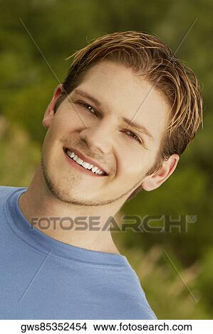 Portrait of a young man smiling View Large Photo Image Picture - Portrait of a young man smiling. Fotosearch