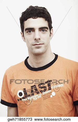 Portrait of a young man smirking View Large Photo Image Stock Image - Portrait of a young man smirking. Fotosearch