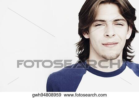 Stock Photo - Portrait of a young man smirking. Fotosearch