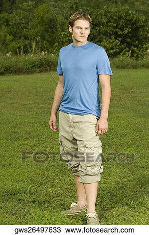 Portrait of a young man standing in the garden View Large Photo Image Stock Image - Portrait of a young man standing in the garden. Fotosearch
